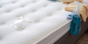 Clean mattress with cleaning supplies for stain removal.